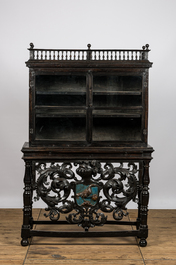 A Spanish ebonised wooden display cabinet on richly carved armorial stand, 19th C.