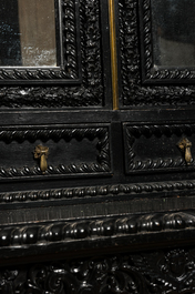 An ebonised wooden cabinet on stand with mirrored doors, 19th C.