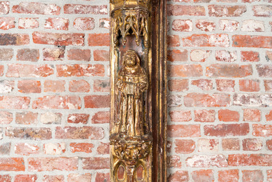 An impressive Gothic Revival carved and gilt wood frame with monks under canopies, 19th C.