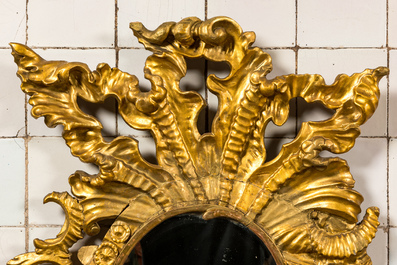 A richly carved gilt wooden Rococo mirror, 18th C.