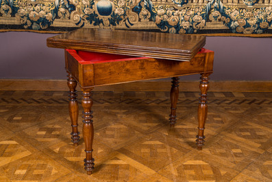 A wooden gaming table with red inner lining, 19th C.