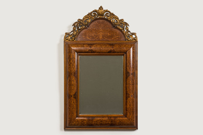A wooden marquetry mirror with gilt wooden ornamental crown, 19th C.