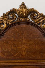 A wooden marquetry mirror with gilt wooden ornamental crown, 19th C.