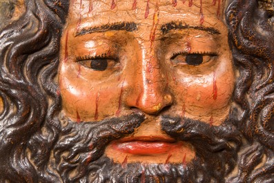 A polychrome wooden 'Christ with the crown of thorns' medallion, probably 17th C.