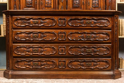 An imposing walnut sacristy cupboard with floral design and garlands, 18th C.