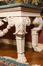 A pair of imposing white patinated consoles with a central mascaron and bluestone top, 19/20th C.