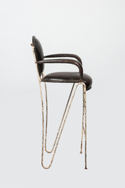 A decorative bar chair in leather and patinated metal, 20th C.