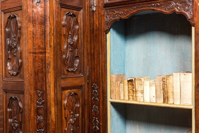 An imposing walnut sacristy cupboard with floral design and garlands, 18th C.