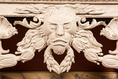 A pair of imposing white patinated consoles with a central mascaron and bluestone top, 19/20th C.