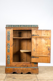 A German polychrome pine single-door cupboard, 18/19th C.