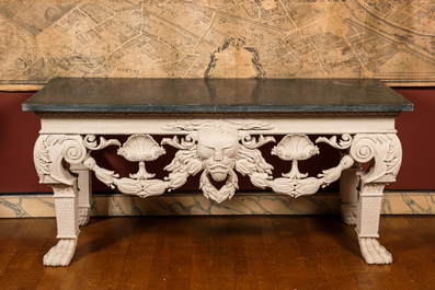 A pair of imposing white patinated consoles with a central mascaron and bluestone top, 19/20th C.