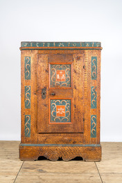 A German polychrome pine single-door cupboard, 18/19th C.