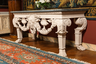 A pair of imposing white patinated consoles with a central mascaron and bluestone top, 19/20th C.