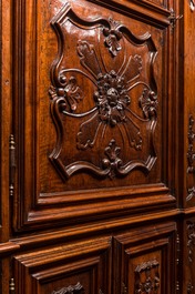 An imposing walnut sacristy cupboard with floral design and garlands, 18th C.