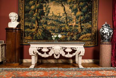 A pair of imposing white patinated consoles with a central mascaron and bluestone top, 19/20th C.