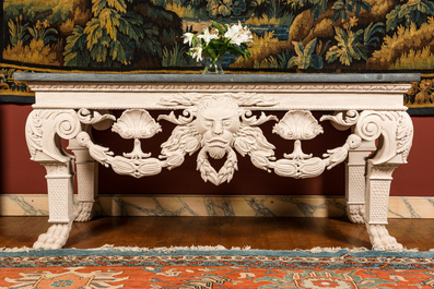 A pair of imposing white patinated consoles with a central mascaron and bluestone top, 19/20th C.