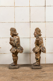 A pair of polychromed and partly gilt walnut sculptures of actors, 17/18th C.