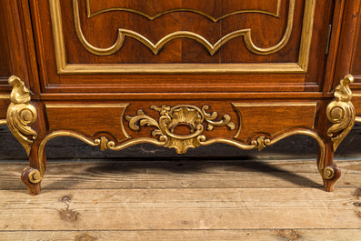 A pair of marble-topped partly gilded wooden side cabinets, 19/20th C.