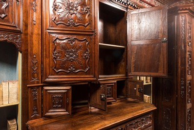 An imposing walnut sacristy cupboard with floral design and garlands, 18th C.