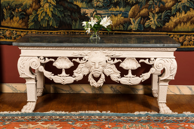 A pair of imposing white patinated consoles with a central mascaron and bluestone top, 19/20th C.