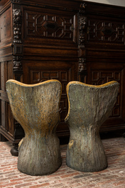 A pair of English naturalistically painted composite stone tree trunk chairs, mid 20th C.