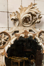 A carved polychrome wooden mirror with floral design, 19th C.