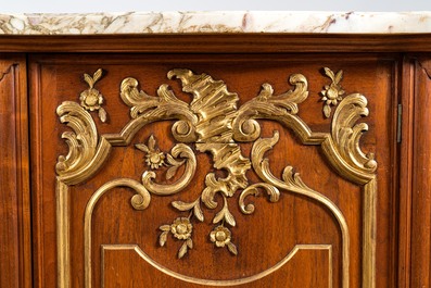 A pair of marble-topped partly gilded wooden side cabinets, 19/20th C.