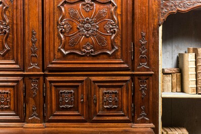 An imposing walnut sacristy cupboard with floral design and garlands, 18th C.