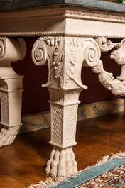 A pair of imposing white patinated consoles with a central mascaron and bluestone top, 19/20th C.