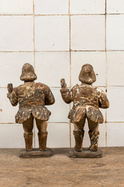 A pair of polychromed and partly gilt walnut sculptures of actors, 17/18th C.