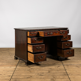 A small wooden nine drawer-desk, 19th C.