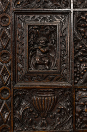 A richly sculpted two-panel French oak room divider with Japonism embroidery, France, 19th C.