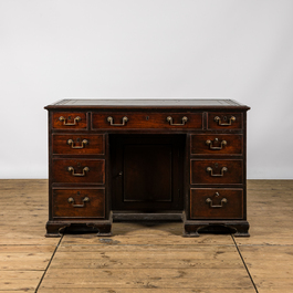 A small wooden nine drawer-desk, 19th C.