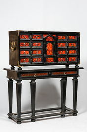 An ebonised wooden cabinet with faux-tortoiseshell veneer, 19th C.