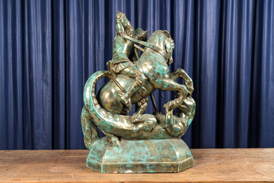 A large faux bronze-patinated pottery group with Saint George beating the dragon, mid 20th C.