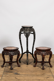 Three Chinese carved wooden stands with marble top, 19/20th C.