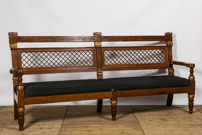 A lavish partly gilt upholstered mahogany bench, probably France, 19th C.