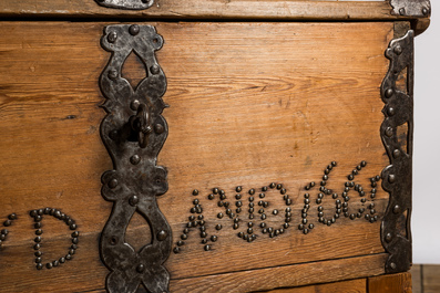 An iron-mounted pine chest on foot, dated 1661, 17th C. and later