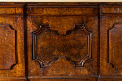 An impressive large Italian walnut and root wood veneer bench with geometric decoration of molded panels, 17th C.