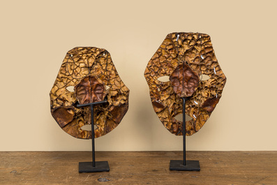 A pair of tortoiseshell masks on a metal base, 20th C.