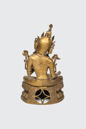 A large gilt copper figure of Tara seated on a lotus throne, India or Nepal, 20th C.