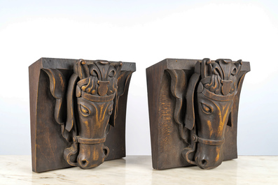 A pair of patinated wooden wall consoles with a horse's head, 20th C.