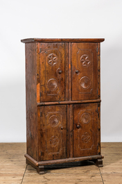 A wooden four-door cupboard with geometrical roundels, Southern Europe, 18/19th C.