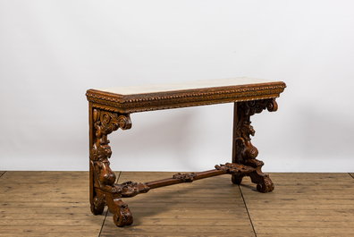 A richly carved wooden wall console with marble top, 19th C.