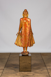 A tall inlaid gilt wooden figure of a standing Buddha, Thailand, 20th C.