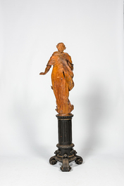 A basswooden allegorical 'Spring' figure on an ebonised neoclassical wooden base, 18/19th C.