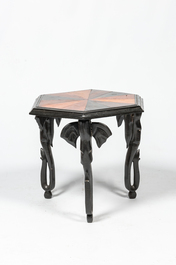 An hexagonal African colonial parquetry side table on elephant legs, 20th C.