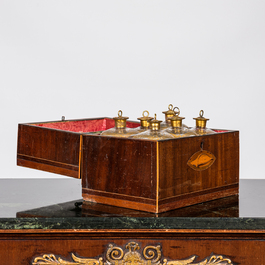 An English mahogany liqueur cellar with six partly gilt carafes, 19th C.