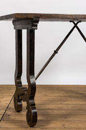 A Spanish walnut table with wrought iron connection, 19th C.