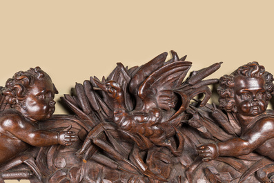A carved oak fronton with two angels around a central duck, late 18th C.
